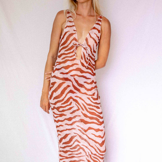 Maxi Dress in Dune animal print, front three-quarter view showing deep V-neckline, front tie detail, and flowing length