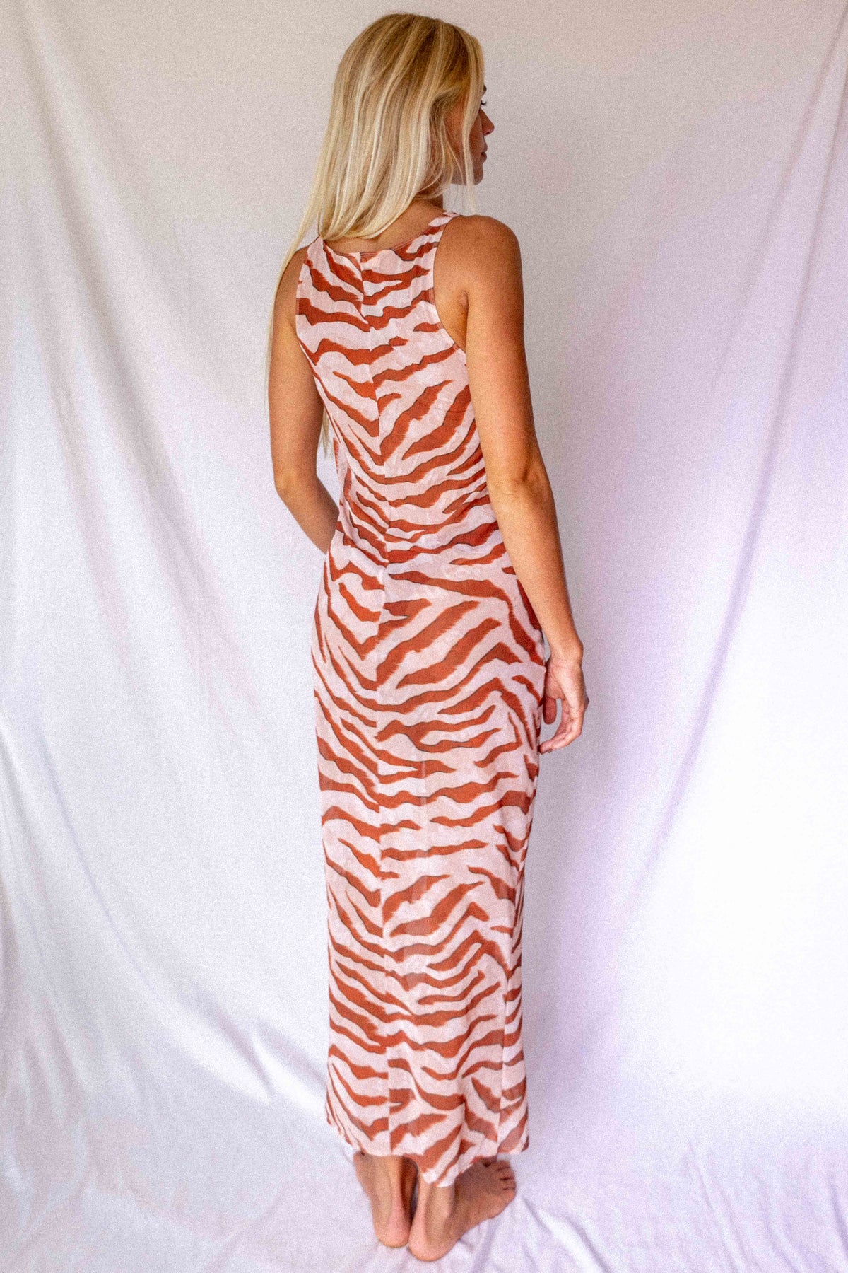 Maxi Dress in Dune animal print, back three-quarter view showing racerback and floor-length flowing silhouette