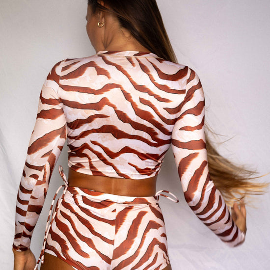 Lola Long-Sleeve Surf Rashguard in Dune animal print, back view worn with matching high-waist bottoms, women's surf rashguard set