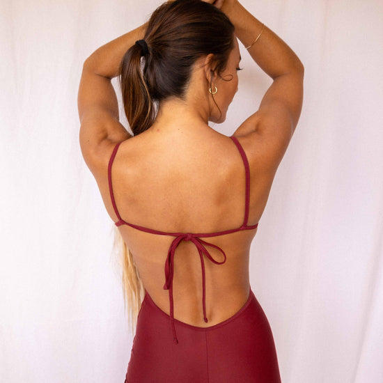 Elle Surf Suit in Deep Merlot — back view showing open back with adjustable tie detail and short cut, Antidote The Label