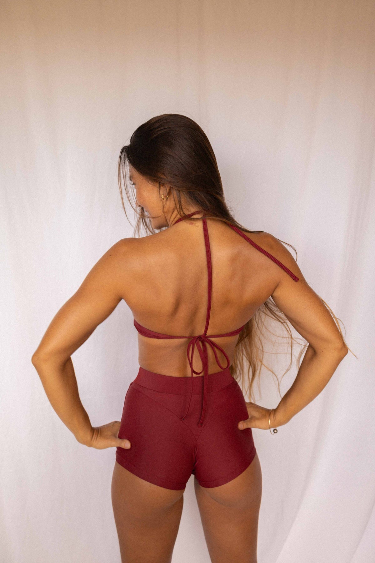 Niki Surf Shorts and Top set in Deep Merlot, full back view showing open back halter straps and high-waist short construction