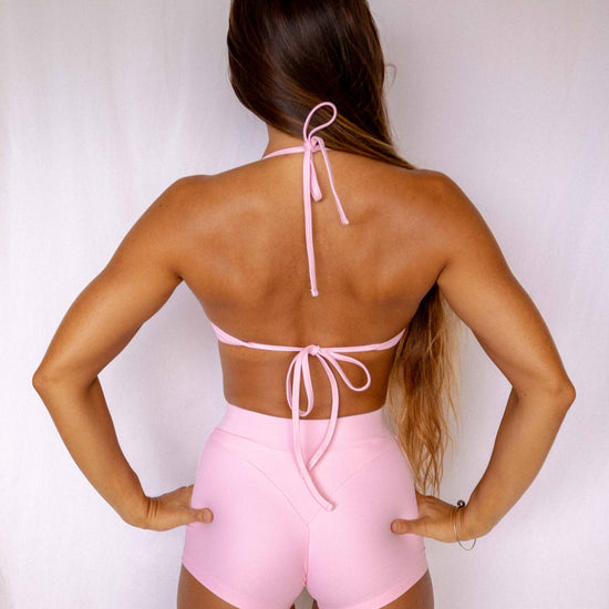 Niki Surf Top in Blush, full back view showing halter neck tie and lower back tie detail worn with matching Niki surf shorts