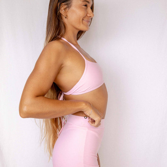 Niki Surf Top and Shorts set in Blush, smiling side profile view showing halter top construction and high-waist short fit by Antidote The Label