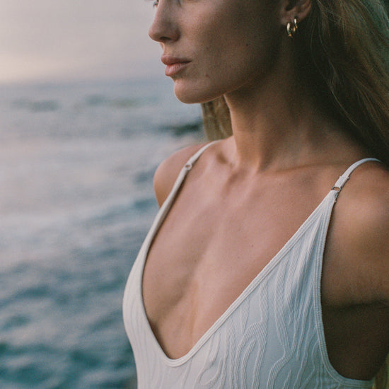 Zoe One Piece in Ivory worn at sunset on the beach, women's one piece swimsuit by Antidote The Label