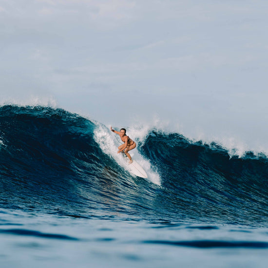 Ona Surf Bottoms in Deep Merlot worn surfing, women's performance surf bikini bottoms by Antidote The Label