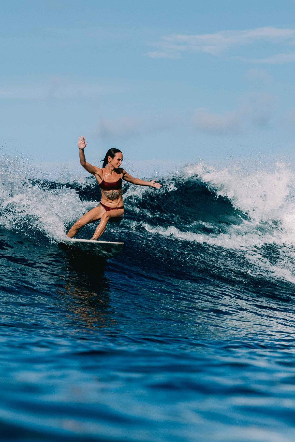 Ona surf bikini set in Deep Merlot worn surfing a wave, women's performance surf bikini by Antidote The Label